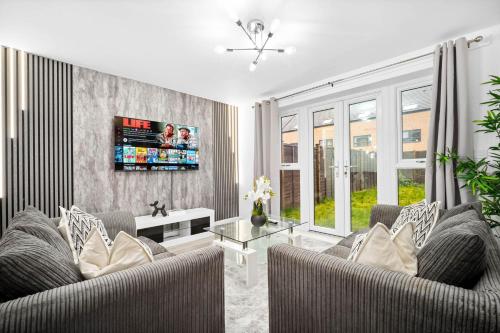 a living room with two couches and a tv at Charming 2-Bedroom Home - Garden & Driveway Parking 20SL in Birmingham