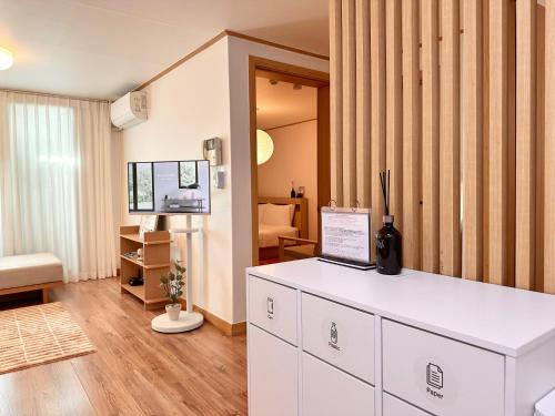 a room with a white counter and a living room at Modern 203 Stay in Seoul