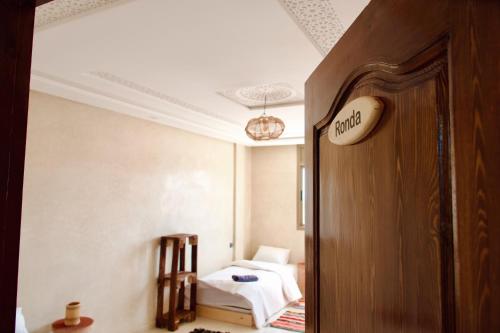 a room with a bed and a door to a bedroom at Cool Surfers in Tamraght Ouzdar