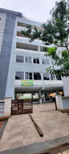 a building with two benches in front of it at RI Krishna Residency in Visakhapatnam