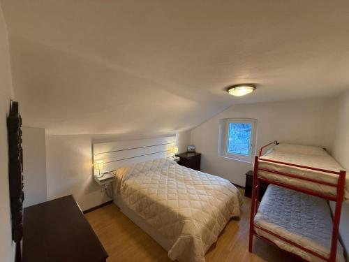 a bedroom with two bunk beds and a window at Dimora Donato 2 bedrooms Lauco UD in Lauco
