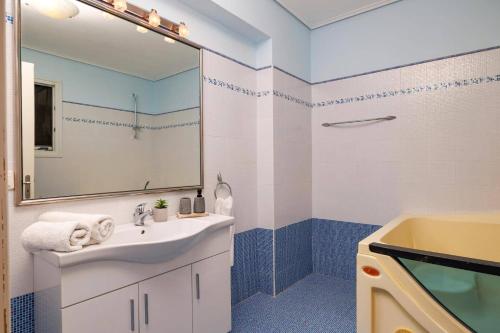 a bathroom with a sink and a mirror at Villa Elea Corfu by Villa Plus in Paleokastritsa