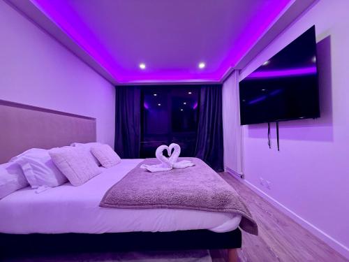 een kamer met een bed met een paars plafond bij Kj Homes in Prénatier