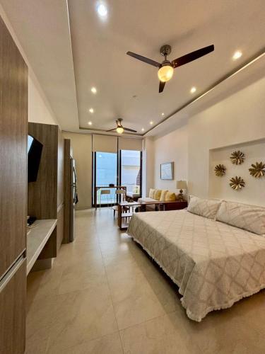 a bedroom with a bed and a view of the ocean at Penthouse Studio 2 blocks from Los Muertos beach in Puerto Vallarta