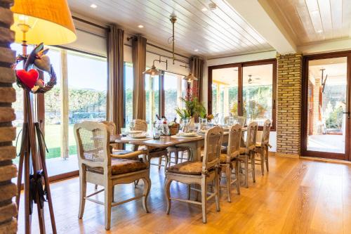 a dining room with a long table and chairs at LeMont Chalet Arachova in Arachova