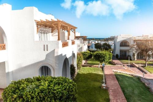 an exterior view of a house with a yard at Jaz Sharm Dream Vacation Club Time Share - Reservation only on Saturdays - Min stay 7 Days in Sharm El Sheikh