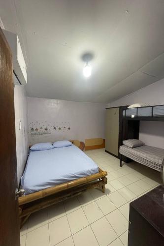 a bedroom with a bed and bunk beds in it at Noahs Ark Bar Restaurant Hostel in Lamai