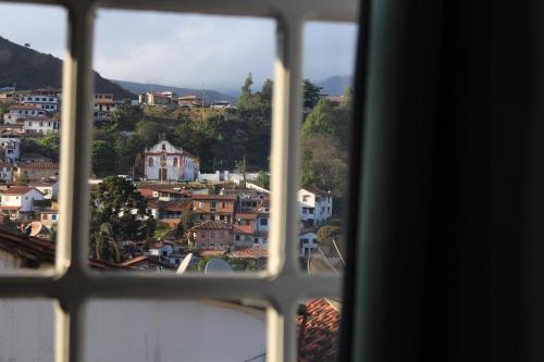 a view of a city from a window at Hotel Luxor in Ouro Preto