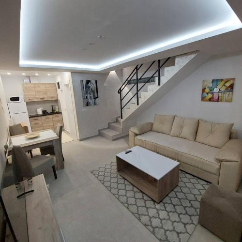 a living room with a couch and a table at Apartman LUX Jelena in Surčin