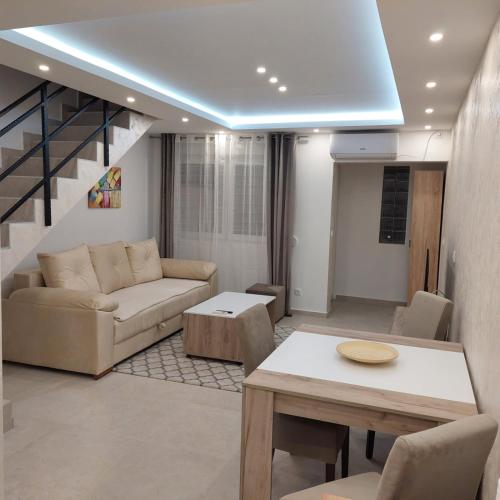 a living room with a couch and a table at Apartman LUX Jelena in Surčin