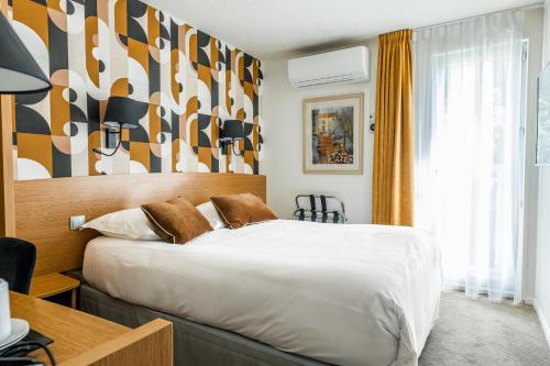 a hotel room with a bed and a large window at Best Western Hotel Acadie Paris Nord Villepinte in Tremblay En France