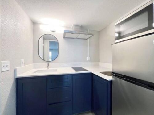 a kitchen with a sink and a refrigerator at ECONOMY INN AND SUITES in Tulsa