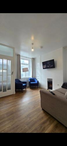 a living room with a couch and a fireplace at Cozy Stays Lancaster in Lancaster