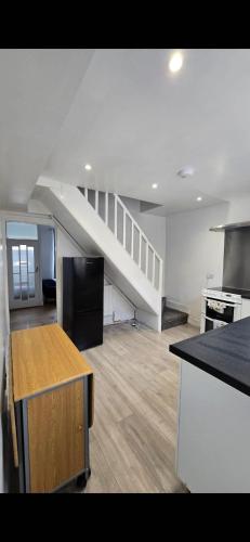 an empty kitchen with a staircase in a house at Cozy Stays Lancaster in Lancaster