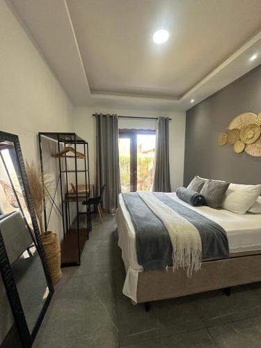 a bedroom with a large bed and a window at Star house Guriú in Guriú
