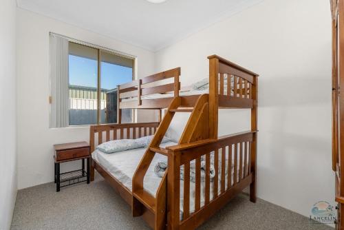 a bedroom with two bunk beds and a window at White Sands in Lancelin