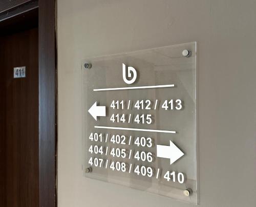 a sign on the side of a door with arrows at Big Inn Luxury Hotel in Biga
