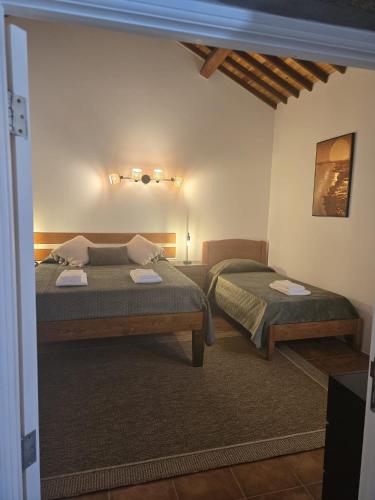 a bedroom with two beds in a room at Recanto Vital in Achadinha