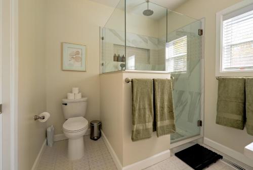 a bathroom with a toilet and a glass shower at Casa Verde in Durham
