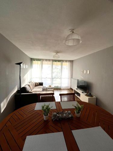a living room with a table and a couch at Home in Cenon in Cenon