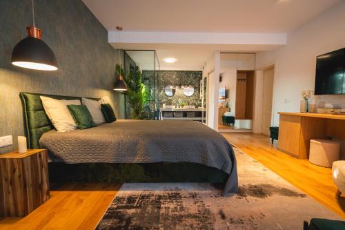 a bedroom with a bed and a living room at Mosia Vasiloaica in Pleaşa