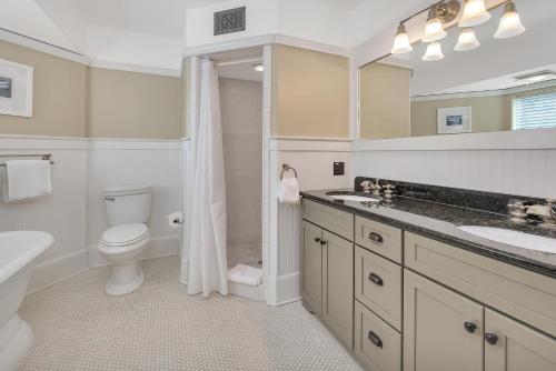a bathroom with a toilet and a sink and a shower at Shiphouse 1 - First Floor in East End