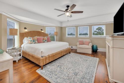 a bedroom with a bed and a ceiling fan at Shiphouse 3 - Third Floor in Saint Simons