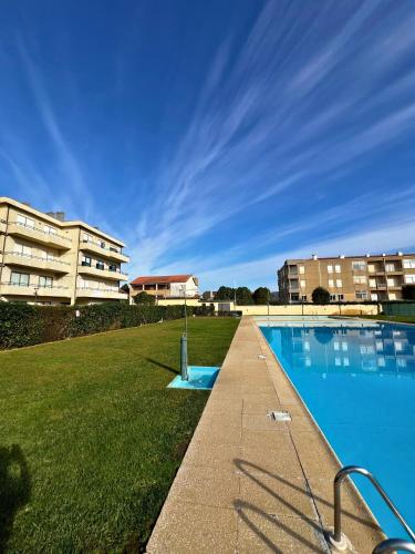 a swimming pool in front of a building at Azurara Beach in Vila do Conde