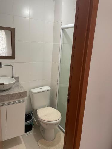 a bathroom with a toilet and a glass shower at Decoradinho RJ in Rio de Janeiro