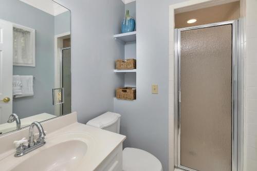 a bathroom with a toilet and a sink and a shower at 26 Coast - Shellbar Cottage in East End