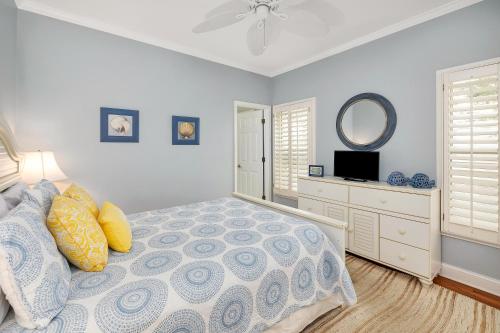 a bedroom with a bed and a mirror at 26 Coast - Shellbar Cottage in East End