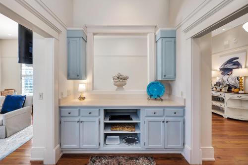 a kitchen with a blue island in a living room at 37 Coast - Ebb Tide Cottage in East End
