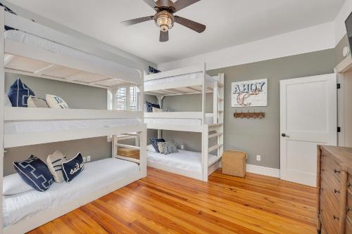 2 Etagenbetten in einem Zimmer mit Deckenventilator in der Unterkunft 16 Coast - Merrimac Cottage in East End