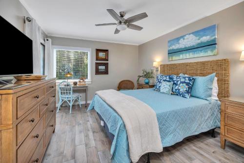 a bedroom with a bed and a flat screen tv at Shipwatch #106 in East End