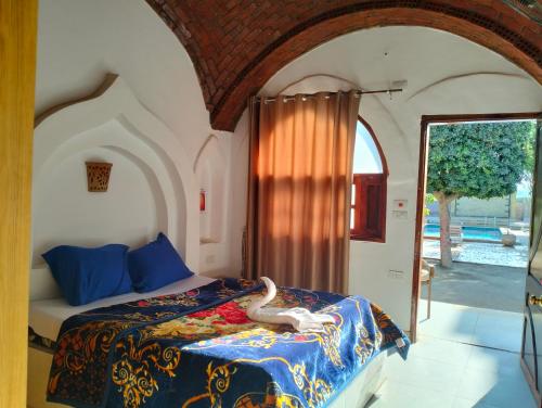 a bedroom with a bed with a snake laying on it at Villa River Nile in Al Qurnah