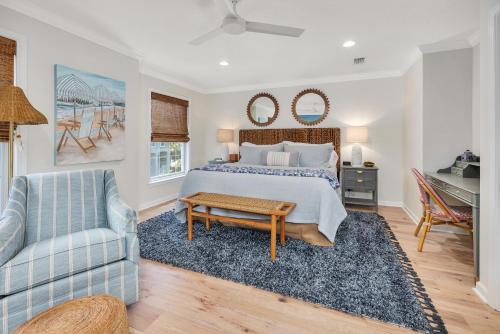 a bedroom with a bed and a couch and a chair at Demere Landing #162 in Saint Simons Island