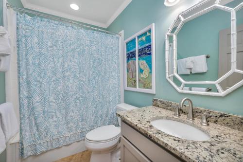a bathroom with a toilet and a sink and a shower at 1126 Park Lane in Demere Park