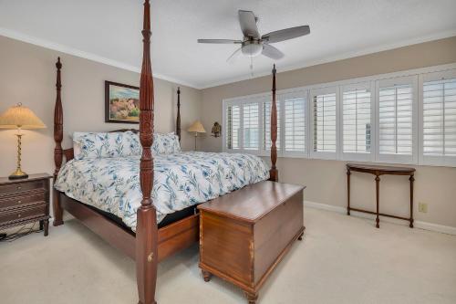 a bedroom with a bed and a ceiling fan at 545 Beachview Dr in Saint Simons