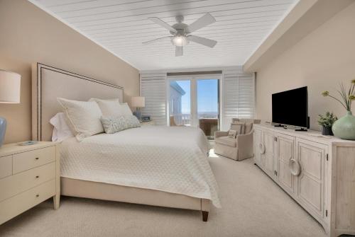a bedroom with a bed and a ceiling fan at St. Simons Grand #325 in East End
