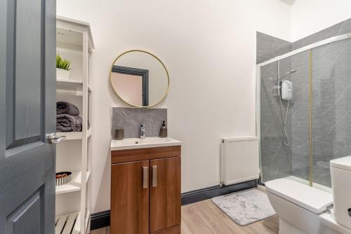 a bathroom with a shower and a sink and a mirror at 5 Bed in Galston oc-s33451 in Galston