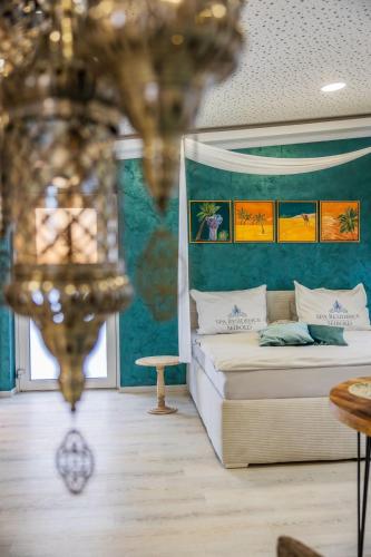 a bedroom with a bed and a chandelier at Spa Residence Seibold in Waldkirchen