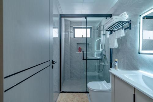 a bathroom with a shower and a toilet and a sink at Tatiana’s Luxury Apartment in Nairobi