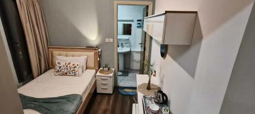 a small bedroom with a bed and a bathroom at Jumeirah Beach Villa in Dubai