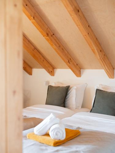 two beds with towels on them in a attic at Oakstone Hills in Nelas