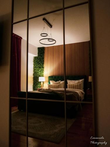 a mirror in a bedroom with a bed in it at Penthouse View Aeroport Iasi in Iaşi