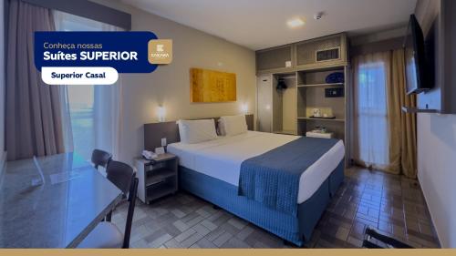 a hotel room with a bed and a tv at Hotel Caiçara João Pessoa in João Pessoa