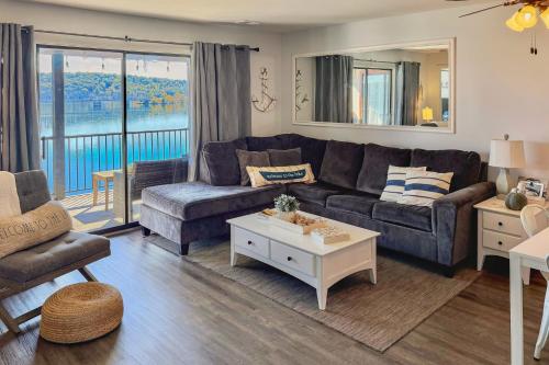 a living room with a couch and a table at Bridgewater Retreat Near SDC - Step-Free Access! in Kimberling City