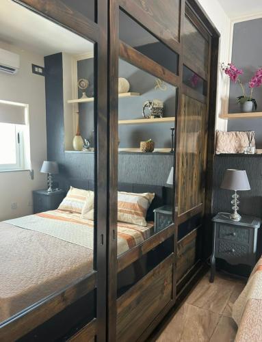 a bedroom with a large wooden bunk bed at Hortensia Room A2 in St. Paul's Bay