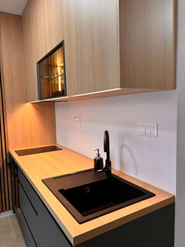 a kitchen with a sink and a counter top at Apartmán nad Dolným Kubínom in Dolný Kubín