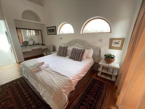 En eller flere senge i et værelse på Supertubes Villa